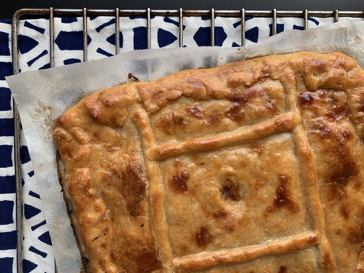 Freshly baked Galician empanada with golden, glazed pastry crust